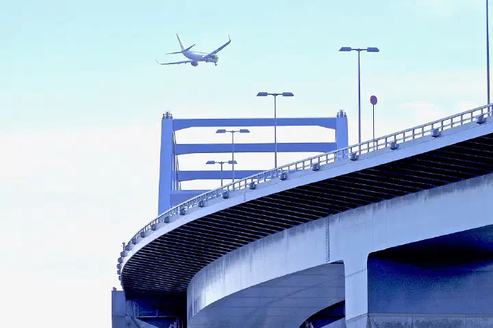 A jetliner approaches Haneda Airport over the Tokyo Gate Bridge in Tokyo Bay.