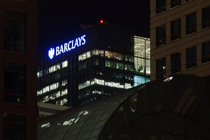 The Barclays building across the City Canal at night.