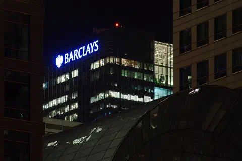 The Barclays building across the City Canal at night.