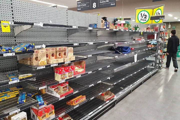 Nearly empty dry-pasta shelves in a supermarket after panic buying during the COVID-19 outbreak.