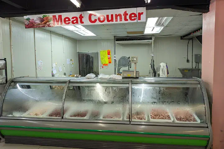 The meat counter at a Honeybee supermarket on El Socorro Road, San Juan, Trinidad.