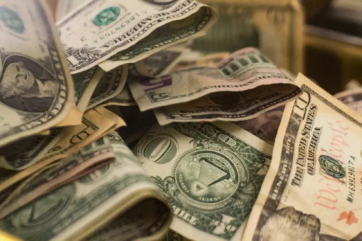 Various United States banknotes in a donation box in the Toledo Museum of Art.