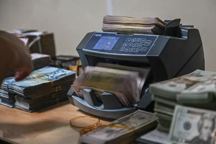 A cash counting machine flips through U.S. currency during a cash count by the 386th Air Expeditionary Wing.