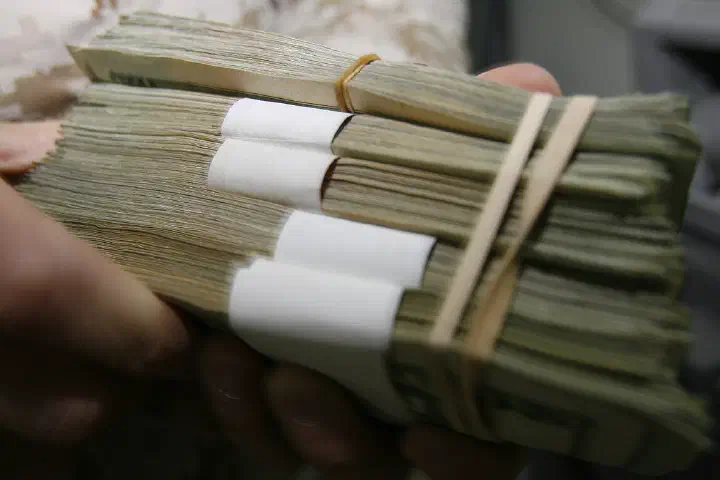 Chief Warrant Officer 2 Charles E. Dennis begins counting the money reserve of the Camp Taqaddum disbursing office, June 29.