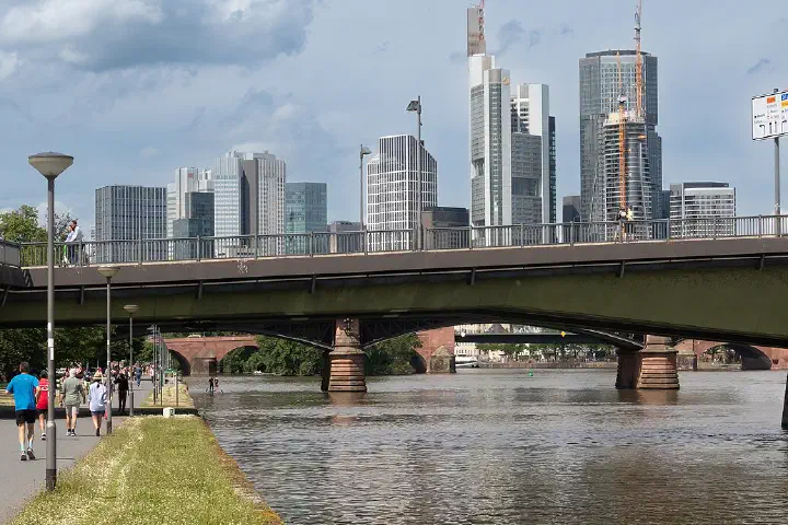 The southern end of the Ignatz Bubis Bridge in Frankfurt am Main, with the skyline behind.
