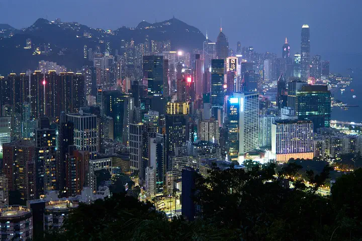 The Hong Kong Island skyline and Victoria Harbour viewed from an elevated vantage point at night.