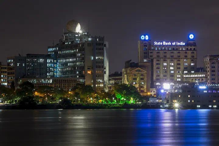 The New Secretariat, left, and State Bank of India buildings at night, seen across the Hooghly River.