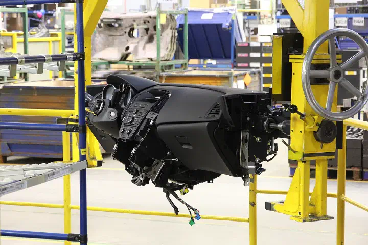 A car dashboard on a factory assembly line.