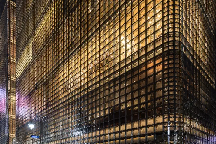 The illuminated Maison Hermès building in Ginza, Tokyo.