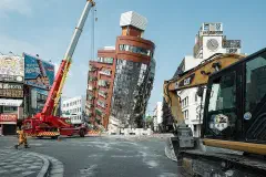 Rescue workers near the semi-collapsed ten-story Uranus Building on Xuanyuan Road after the 2024 Hualien earthquake