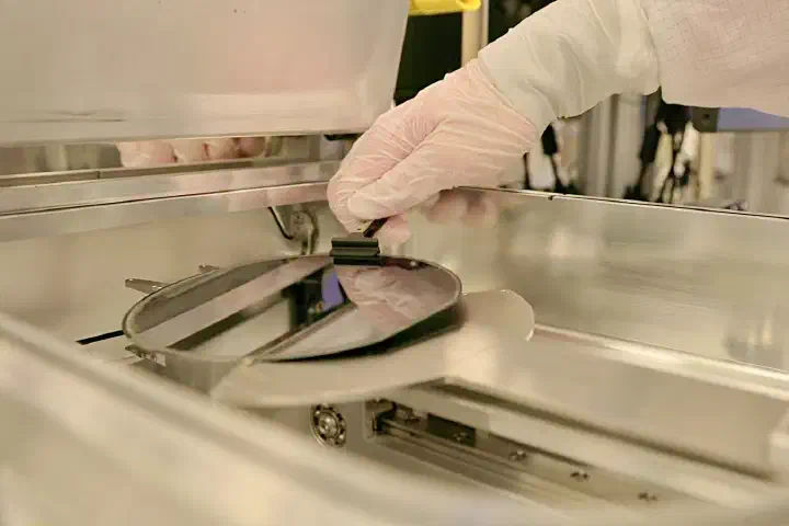 A semiconductor wafer being removed from processing equipment.