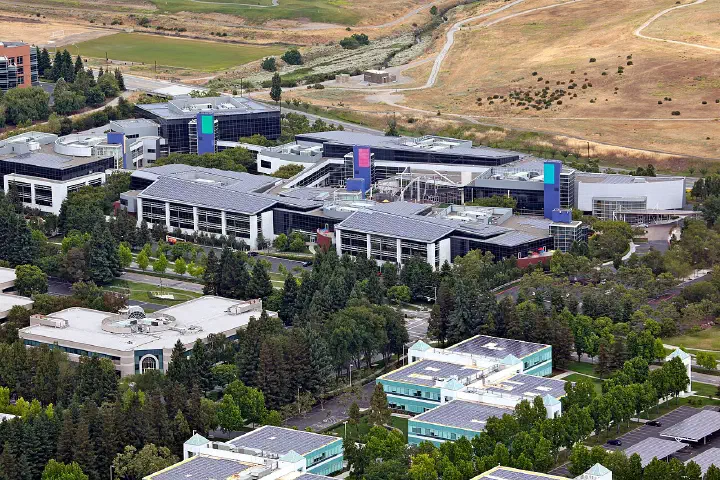 Solar panels cover the rooftops and car parks of the Googleplex, seen from a Zeppelin NT.