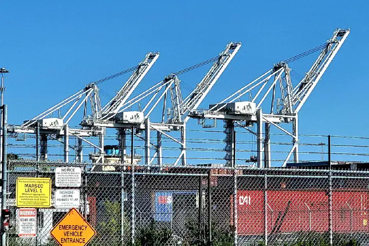 Three container cranes at the Port of Oakland, California.