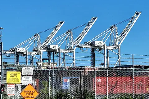 Three container cranes at the Port of Oakland, California.