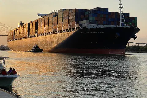 The CMA CGM Marco Polo passes through the Port of Savannah, Georgia, at sunset.