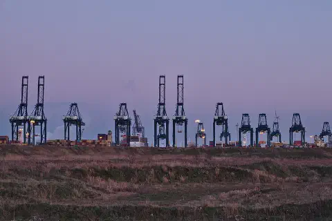 Container cranes at the MPET- MSC PSA European Terminal in Port of Antwerp (Kieldrecht, Belgium) during the sunset civil twilight