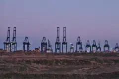 Container cranes at the MPET- MSC PSA European Terminal in Port of Antwerp (Kieldrecht, Belgium) during the sunset civil twilight
