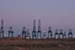 Container cranes at the MPET- MSC PSA European Terminal in Port of Antwerp (Kieldrecht, Belgium) during the sunset civil twilight