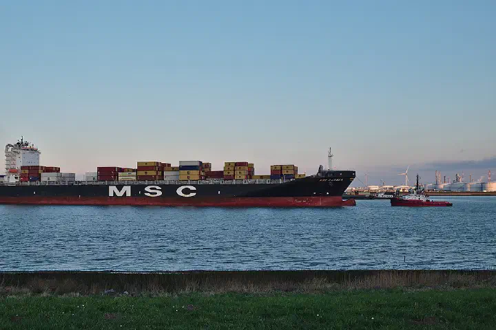 MSC Carmen container ship being towed in the Scheldt towards the Port of Antwerp, seen from Doel, Belgium