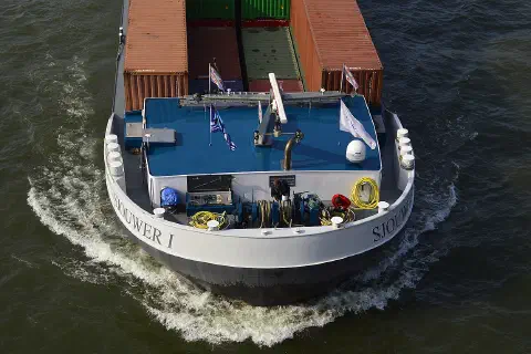 Men working on the Dutch cargo ship Sjouwer I on the Rhine near Cologne, 2019.