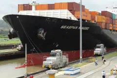 Locomotives Tow Container Ship through Miraflores Locks - Panama Canal - Panama