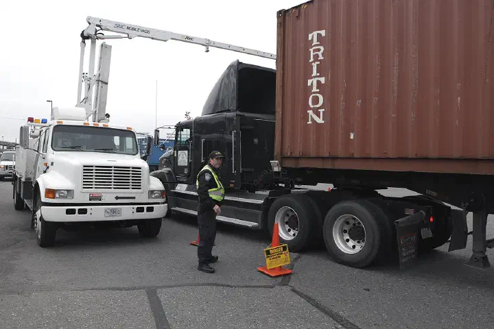 A U.S. Customs and Border Protection officer stands by to inspect vehicles.