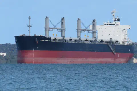 The bulk carrier Bulk Monaco in Cockburn Sound, Western Australia, seen from near the CGH Grain Jetty, with Garden Island in the background.