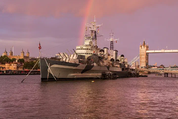 HMS Belfast beneath a rainbow.