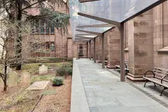 A modern steel-and-glass canopy on the south terrace of Trinity Church, Wall Street, designed by MBB Architects.