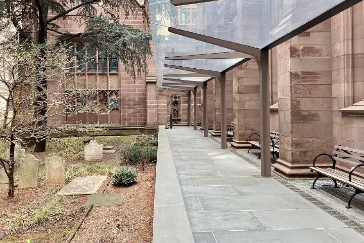 A modern steel-and-glass canopy on the south terrace of Trinity Church, Wall Street, designed by MBB Architects.