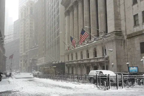 Broad Street at Wall Street, in front of the New York Stock Exchange, during a snowstorm on February 9, 2017.